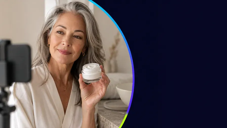 A creator holding a jar of cream up to camera
