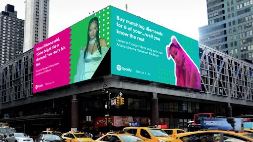 City billboards for a Spotify and Tiffany & Co. Ariana Grande promotion above busy traffic